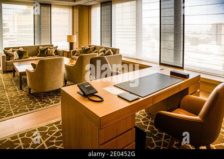 The living room of a 120-square-metre suite on the 15th floor of The Okura Tokyo's Heritage wing, Minato ward, Japan, is decorated in light wood and fabric tones. Clean lines and a touch of 1960s chic define the décor. Stock Photo