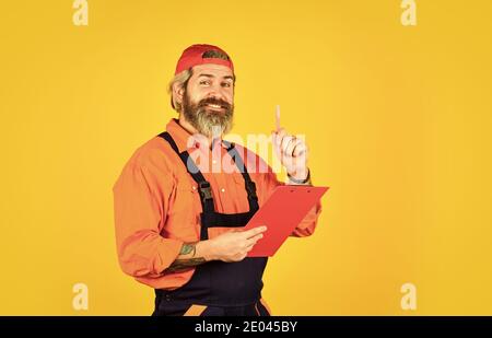portrait of engineering man. construction worker holding folder. Structural plan safety. work operation concept. looking project folder. blueprint in folder. making notes in clipboard. Stock Photo