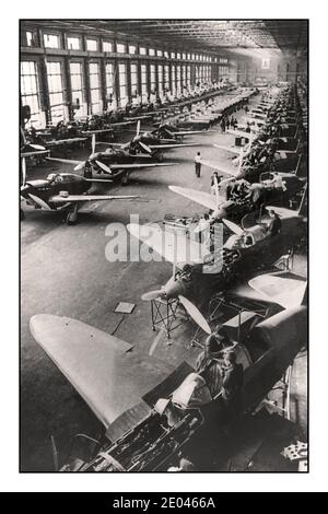 1942 Soviet WW2 Fighter Airplane Production Line “Yak' fighter planes, for the Soviet Russian air force, on the assembly lines at a Soviet factory somewhere in the USSR, March 1942 interior view of a factory with Russian fighter planes being manufactured on an assembly line. 1942. World War II Second World War Soviet USSR Russia -  Fighter planes--Russian--1940-1950 -  Factories--Soviet Union--1940-1950 -  Assembly-line methods--Soviet Union--1940-1950 -  World War, 1939-1945--Equipment & supplies--Russian -  World War, 1939-1945--Air operations--Russian Stock Photo