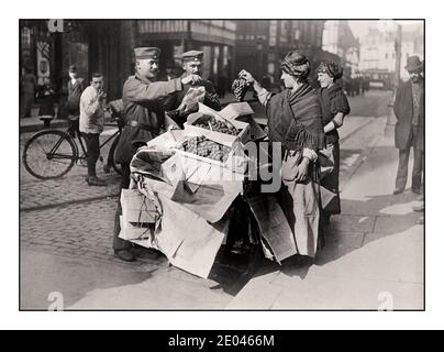WW1 German Propaganda image of German soldiers buying apparently plentiful fruit /grapes -- on Belgian Street market stall in Belgium during World War 1 Photograph shows German soldiers purchasing grapes from women with a street cart in Belgium during World War I.  1915 April 13  World War 1, 1914-1918 Glass negatives.First World War Stock Photo