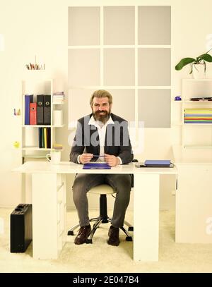 Man sit office. Business director. Bearded hipster creative director. Advocacy and jurisprudence. Legal services director. Case manager track paperwork and other important information about case. Stock Photo