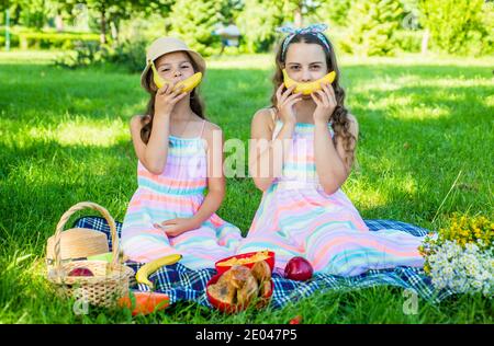 This banana wants you to be happy. Happy children have fun with banana. Picnic meal. Healthy nutrition. Benefits of fruit. Pediatric dentistry. Dental health. Summer vacation. Childrens day. Stock Photo