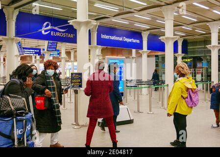 A family entering Eurostar International Departures and St Pancras International Train Station.
