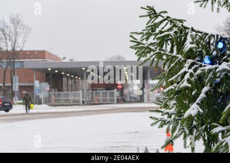 Narva, Estonia. December 23, 2020 A branch of decorated spruce against the background of Estonian customs. High quality photo Stock Photo