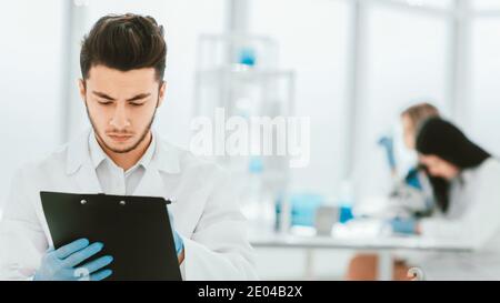 close up. a scientist doing writes the results of an experiment Stock Photo