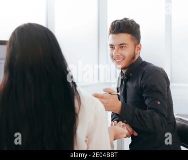 rear view. two employees discuss work issues sitting at the off Stock Photo