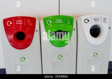 Red for plastic bottles, green for mixed recycling and white for general waste, recycling bins Stock Photo