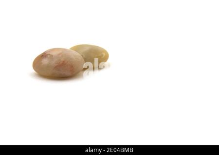 Two pebble stones on a white background with copy space to the right of the image Stock Photo