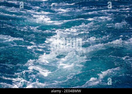 Sea wave and boat motor foaming view, bright color and crystal clean water Stock Photo