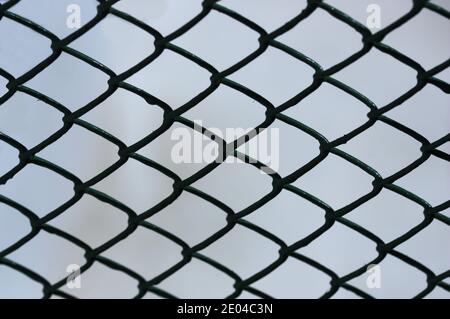 Image of a metal fence that forms small rhombuses in its structure Stock Photo