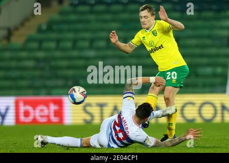 Norwich, Norfolk, UK. 29th December 2020; Carrow Road, Norwich, Norfolk, England, English Football League Championship Football, Norwich versus Queens Park Rangers; Geoff Cameron of Queens Park Rangers slides in and challenges Oliver Skipp of Norwich City Credit: Action Plus Sports Images/Alamy Live News Stock Photo