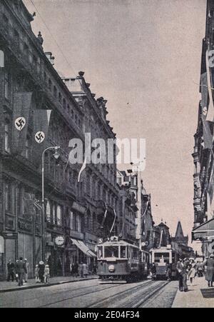 PRAGUE, PROTECTORATE OF BOHEMIA AND MORAVIA - 1942: Unkown street in Prague. Nazi Swastika flags on building. Stock Photo