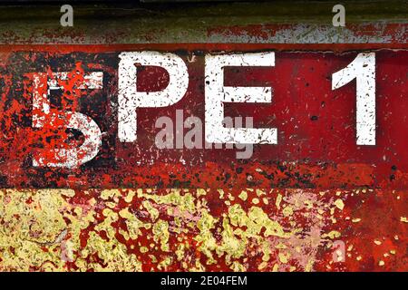 White letters and numbers 5PE1 on a fishing boat with peeling paint. Stock Photo