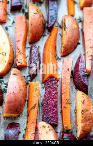 restaurant, vegetarianism, fast, health, recipes concepts - Oven baked cut vegetables potatoes carrots, mushrooms with seasoning dill. Roasted Stock Photo