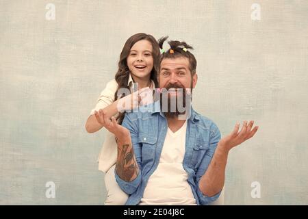 Having fun. happy family day. small girl play with dad. bearded man father having fun with kid. childrens day. love and trust. daughter and father with funny hairdo. hairdresser and barbershop. Stock Photo