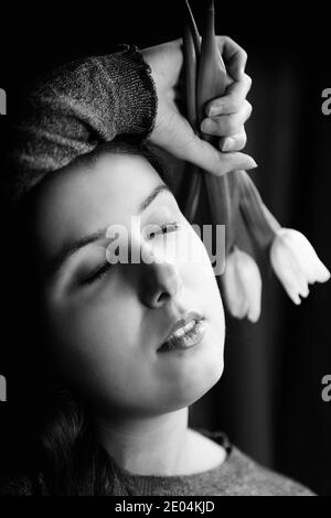 teenager with tulips in hand II Stock Photo