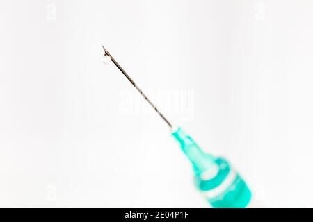 Needle with drop isolated on white background, macro Stock Photo