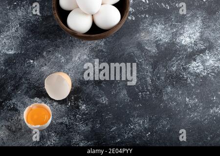 Bowl of white eggs and yolk on marble background Stock Photo