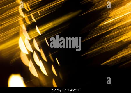 Abstract illuminating golden backdround with linear and spherical shapes. Isolated black background for text entry Stock Photo
