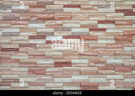 Natural craft stone tile wall made to random pattern background. Stock Photo