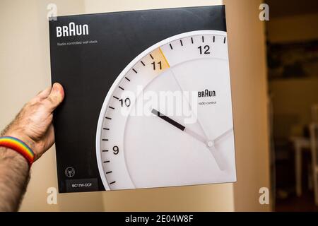 Paris, France - Dec 8, 2020: POV personal perspective male hand holding pakcage of new Braun Stock Photo