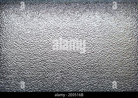 Gray corrugated texture of interior glass window with light coming from behind. Can be used as background for designs. Stock Photo