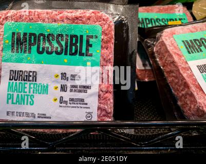 Rockville, MD, USA 12-21-2020: Packs of frozen Impossible Burgers on supermarket freezer shelves. It is an innovative all plant based meat alternative Stock Photo