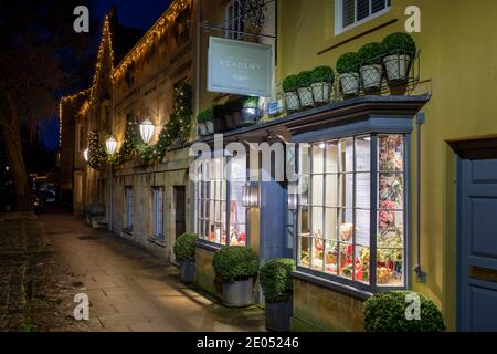 The Covent Garden Academy of Flowers along the high street with christmas lights at dawn. Chipping Campden, Cotswolds, Gloucestershire, England Stock Photo