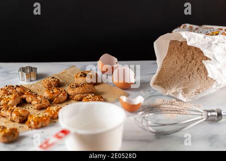 View of fresh out of oven handmade cookies and biscuits made with wholewheat flour, egg and decorated with sesame and poppy seeds. They are on baking Stock Photo