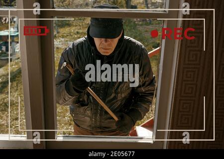 View CCTV house breaking through the window with a crowbar. Stock Photo