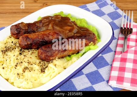 Sausage and mashed potato meal with mushy peas in a metal enamel dish Stock Photo