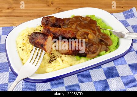 Sausage and mashed potato meal with mushy peas in a metal enamel dish Stock Photo