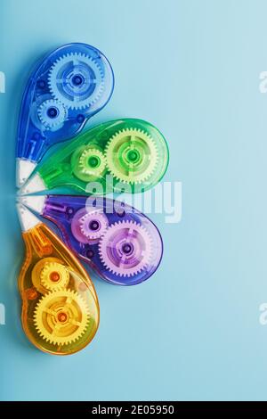 Multi-colored Stationery correction tapes on a blue background. Free space. The view from the top Stock Photo
