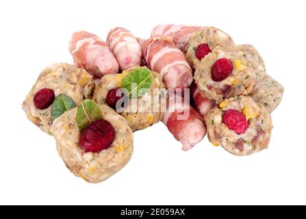 Group of raw pigs in blankets and pork stuffing balls with cranberries isolated on a white background Stock Photo