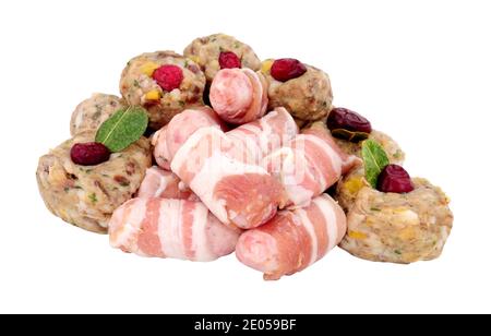 Group of raw pigs in blankets and pork stuffing balls with cranberries isolated on a white background Stock Photo