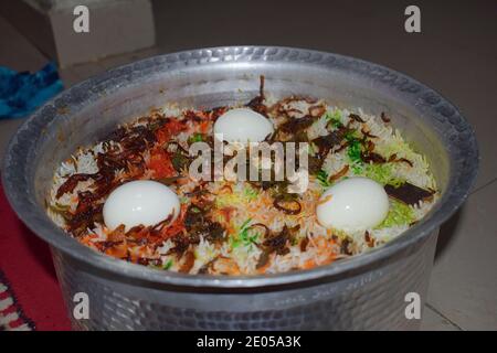 Handi of Homemade Tandoori chicken biryani with Eggs, Traditional Indian food, Pune Stock Photo