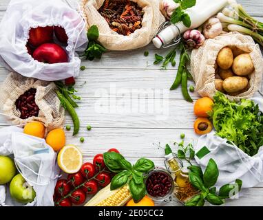 Zero waste shopping and sustanable lifestyle concept, various farm organic vegetables, grains, pasta and fruits in reusable packaging supermarket bags Stock Photo