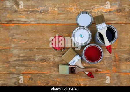 Paint cans and brushes on the old wooden background. Concept of house renovation Stock Photo