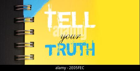 Tell your truth text message words on yellow page of copybook in white and blue. Social political concept Stock Photo