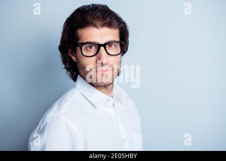 Photo portrait of serious concentrated man looking at camera isolated on clear white colored background with blank space Stock Photo