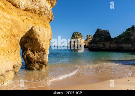 idyllic beautiful beach with rock formations and turquoise water on the Algarve Stock Photo