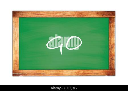 GO text written on green wooden frame school blackboard. Stock Photo
