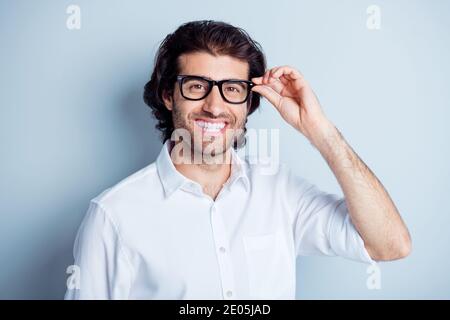 Photo portrait of positive man holding glasses isolated on clear white colored background Stock Photo