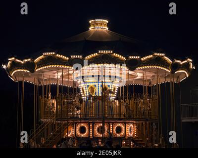The carousel in the amusement park in the lights at night Stock Photo