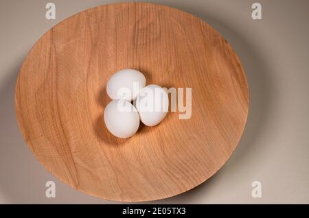 Three White Eggs In A Handmade Wooden Bowl Stock Photo