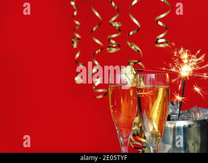 Glasses, bottle of champagne and sparklers. Festive template background Stock Photo