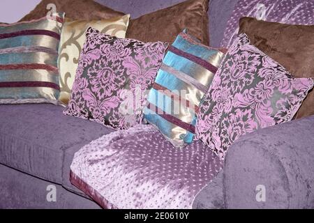 Bunch of purple pillows on the sofa Stock Photo