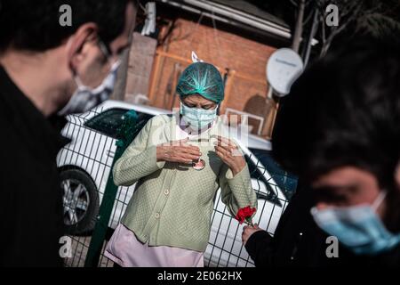 A nurse wearing a facemask is seen having a tag on her shirt reading "Let COVID-19 be accepted as an occupational disease" during the commemoration. Health, Labor and Professional Organizations commemorated their colleagues who lost their lives due to COVID-19 in front of Ankara Training and Research Hospital. Stock Photo