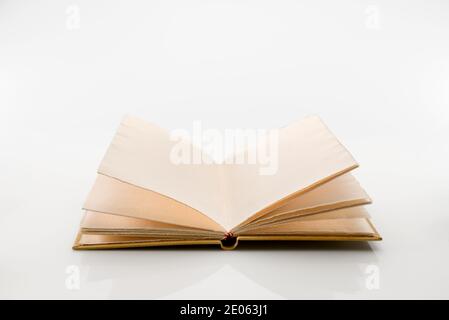 Open antique style book with pages of rough paper with jagged edges, antique leather hardcover notebook isolated on white background Stock Photo