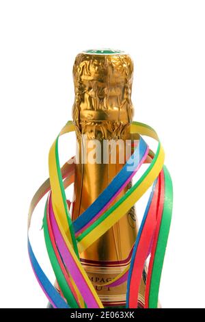 Christmas and New Year celebration concept. Close up of top of champagne bottle with paper ribbon, cut out on white background Stock Photo